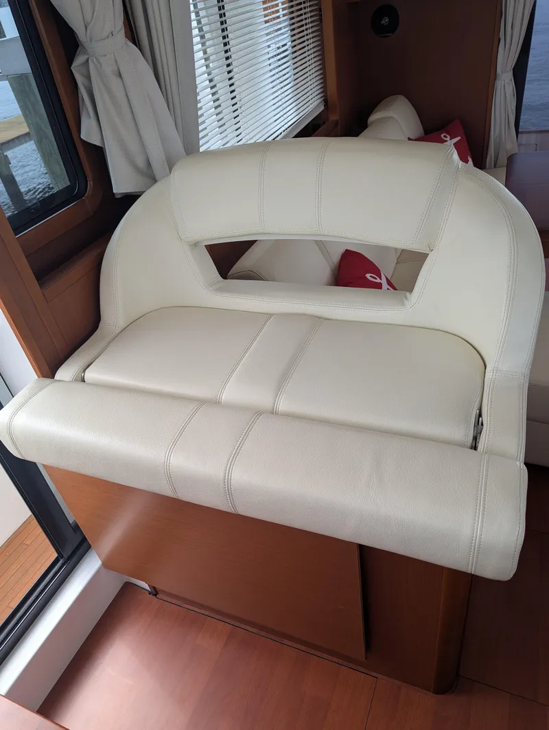 Slide: The Image of Interior seating of 2019 Beneteau Swift Trawler 44, featuring cream leather upholstery. - 35