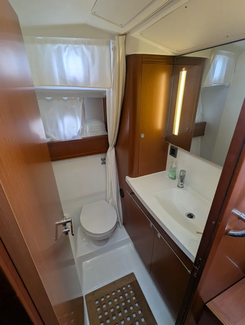 Slide: The Image of 2019 Beneteau Swift Trawler 44 bathroom with modern fixtures and wooden cabinetry. - 39