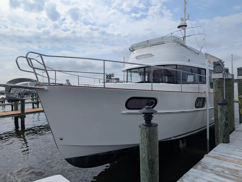 Slide: The Image of 2019 Beneteau Swift Trawler 44 docked at marina under cloudy sky. - 4