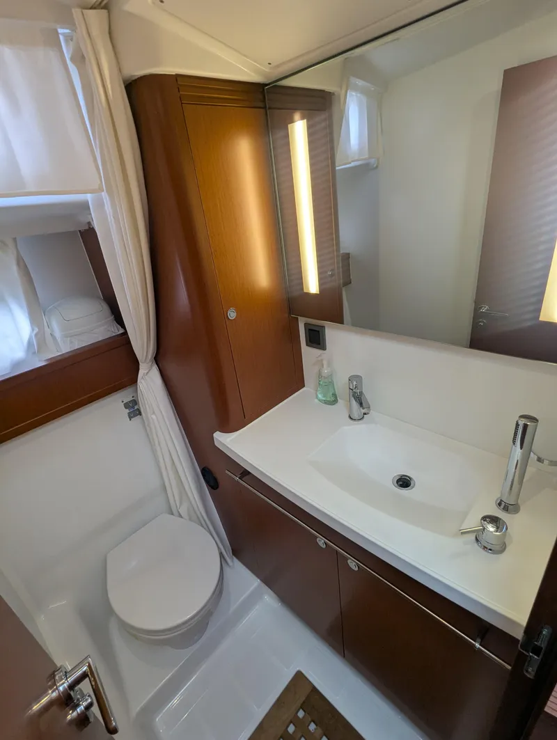 Slide: The Image of 2019 Beneteau Swift Trawler 44 bathroom with modern sink, mirror, and wooden cabinetry. - 40