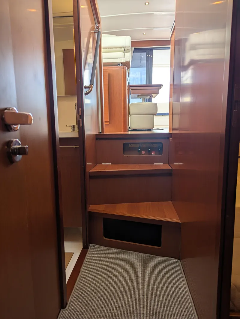 Slide: The Image of Interior view of 2019 Beneteau Swift Trawler 44, featuring wooden stairs and modern design. - 46