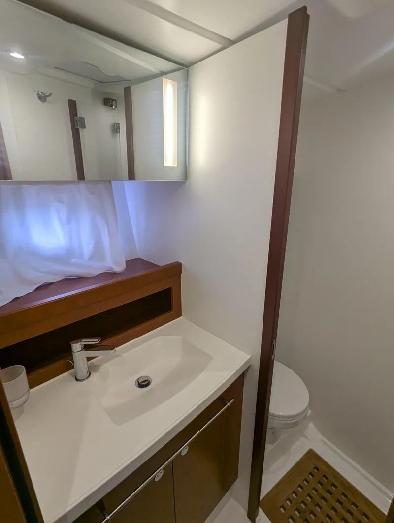 Slide: The Image of Bathroom interior of 2019 Beneteau Swift Trawler 44, featuring sink and toilet. - 47