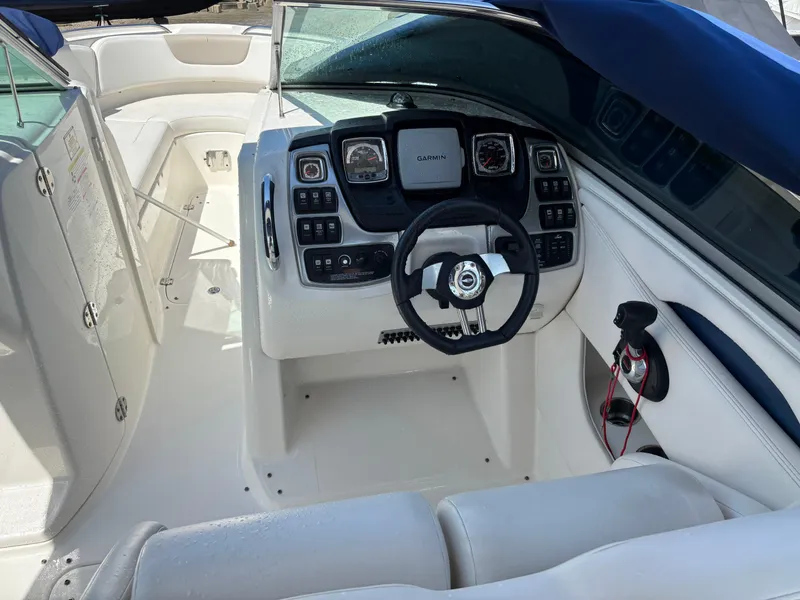 Slide: The Image of Interior view of 2012 Chaparral 287 SSX boat cockpit with steering wheel and controls. - 10