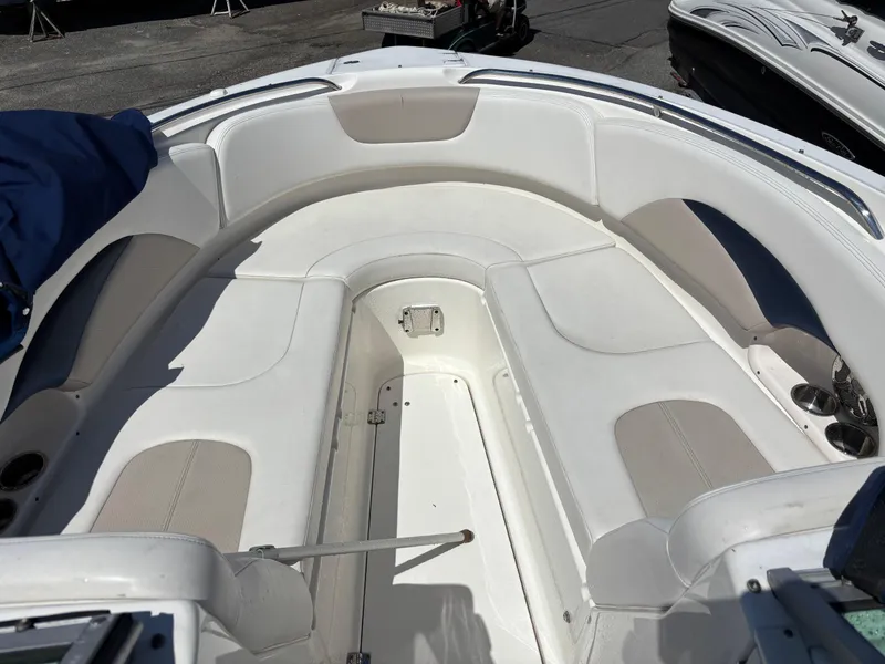 Slide: The Image of 2012 Chaparral 287 SSX boat interior with white seating and cup holders. - 12