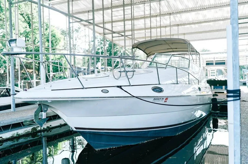 The Image of 2001 Cruisers Yachts 3075 Express docked in a covered marina. - 0