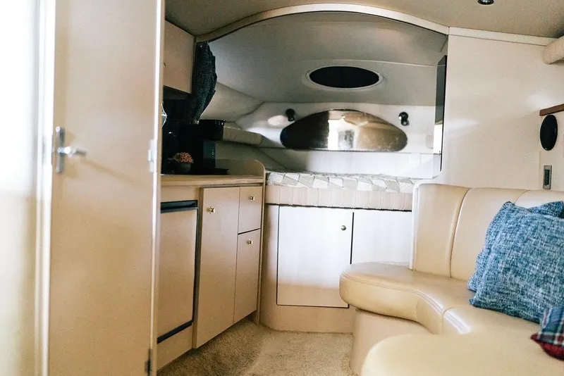 Slide: The Image of Interior of 2001 Cruisers Yachts 3075 Express, featuring cozy cabin and kitchenette. - 10