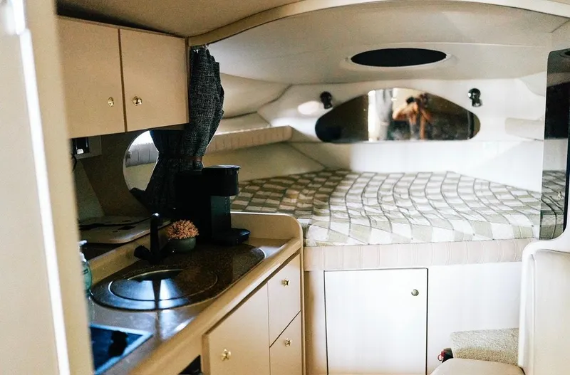 Slide: The Image of Interior of 2001 Cruisers Yachts 3075 Express with plush seating and decorative pillows. - 11