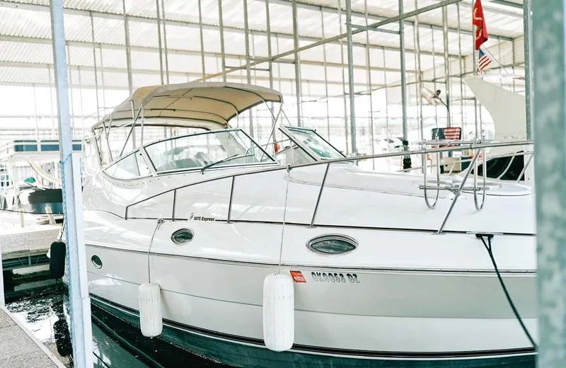 Slide: The Image of 2001 Cruisers Yachts 3075 Express, white exterior, docked in marina setting. - 18