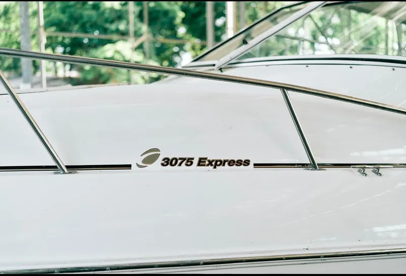 Slide: The Image of 2001 Cruisers Yachts 3075 Express boat with canopy in marina setting. - 4