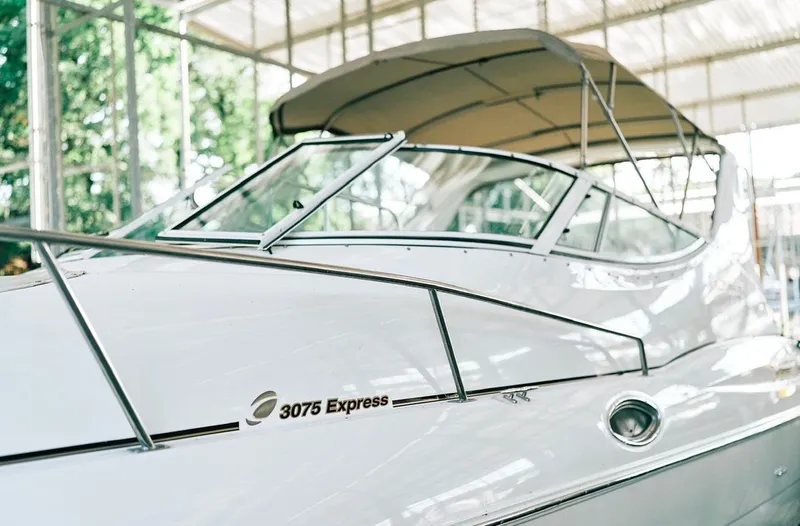 Slide: The Image of 2001 Cruisers Yachts 3075 Express docked under a covered marina. - 5