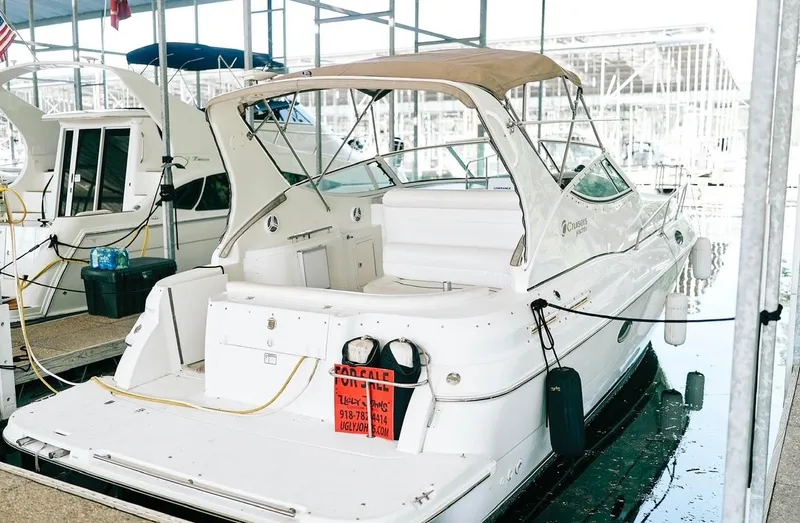 Slide: The Image of 2001 Cruisers Yachts 3075 Express docked, white exterior, for sale sign visible. - 15