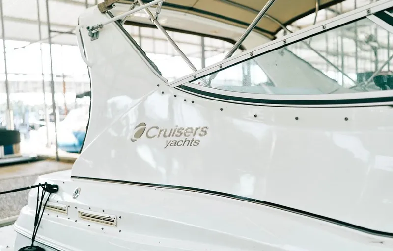 Slide: The Image of 2001 Cruisers Yachts 3075 Express, white exterior, docked in marina setting. - 19