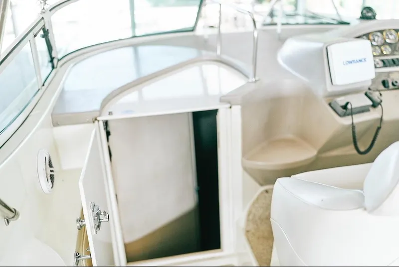 Slide: The Image of 2001 Cruisers Yachts 3075 Express cockpit with open cabin door and navigation equipment. - 8