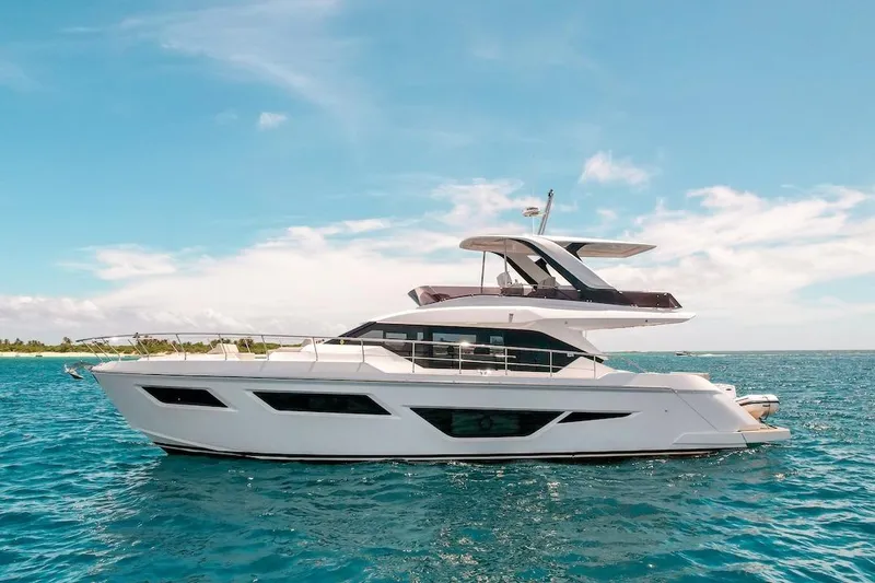 The Image of 2024 Ferretti Yachts 580 cruising on clear blue ocean under a sunny sky. - 0