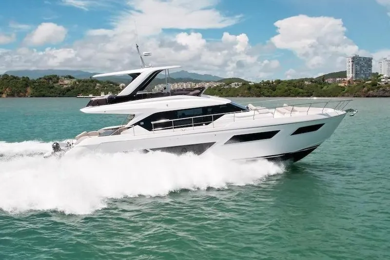 Slide: The Image of 2024 Ferretti Yachts 580 cruising on turquoise waters under a clear blue sky. - 10