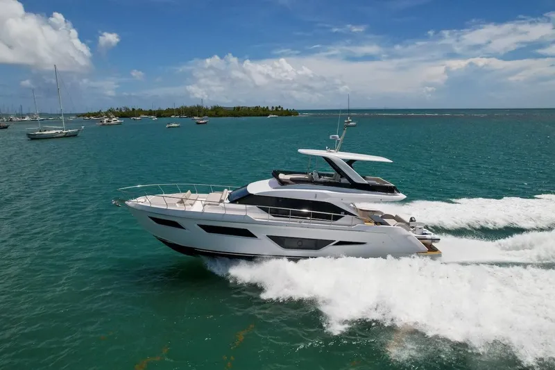 Slide: The Image of 2024 Ferretti Yachts 580 cruising on turquoise waters under a clear blue sky. - 16