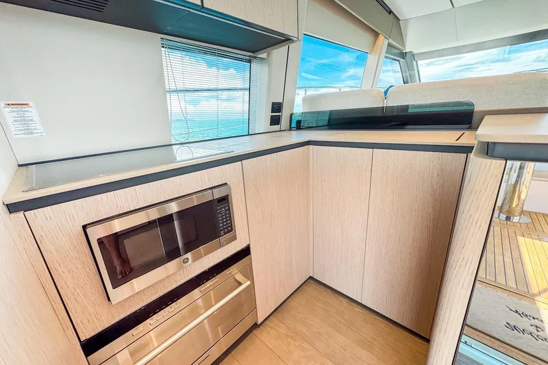 Slide: The Image of Modern kitchen interior of 2024 Ferretti Yachts 580, featuring sleek cabinetry and ocean view. - 21