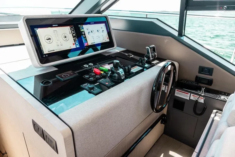 Slide: The Image of 2024 Ferretti Yachts 580 helm with advanced navigation controls and dual display screens. - 30