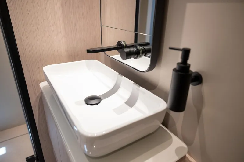 Slide: The Image of Modern bathroom sink in 2024 Ferretti Yachts 580, featuring sleek design and black fixtures. - 38