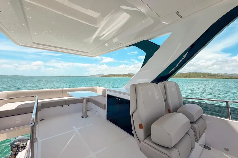 Slide: The Image of Luxurious 2024 Ferretti Yachts 580 interior with ocean view and elegant seating. - 48