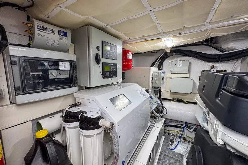 Slide: The Image of Engine room of 2024 Ferretti Yachts 580, featuring control panels and filtration systems. - 55
