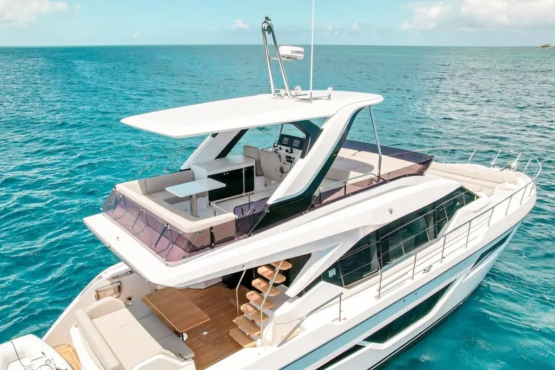Slide: The Image of Luxurious 2024 Ferretti Yachts 580 cruising on clear blue ocean waters. - 6