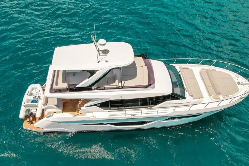Slide: The Image of 2024 Ferretti Yachts 580 cruising on clear blue water, aerial view. - 7