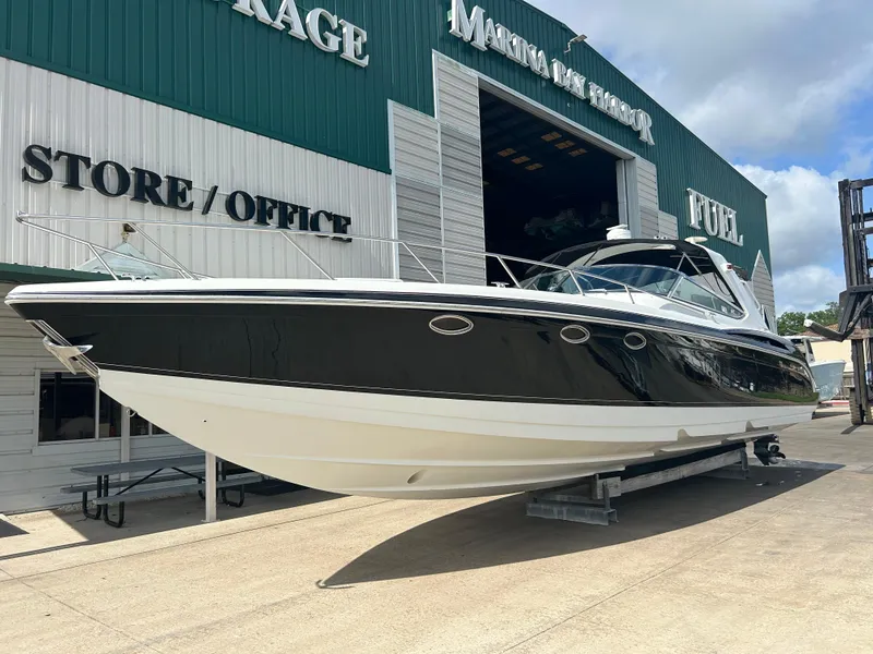 The Image of 2004 Formula 400 SS boat at marina storage, black and white exterior, sunny day. - 1