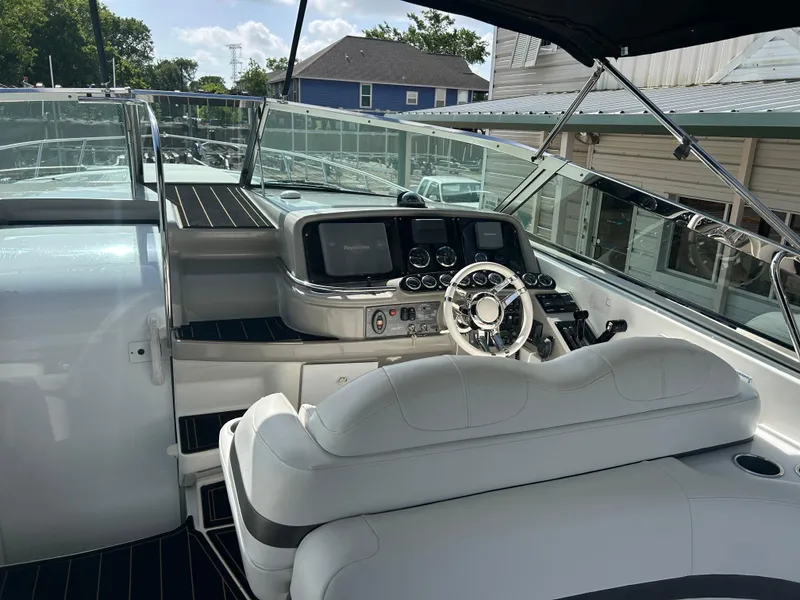 Slide: The Image of 2004 Formula 400 SS boat cockpit with modern controls and white seating. - 13