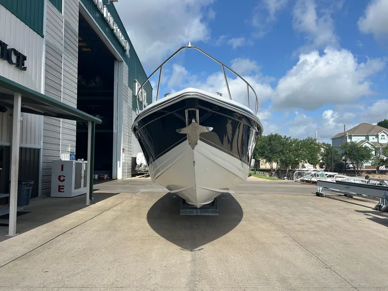 Slide: The Image of 2004 Formula 400 SS boat on dry dock, sunny day, blue sky, marina background. - 2