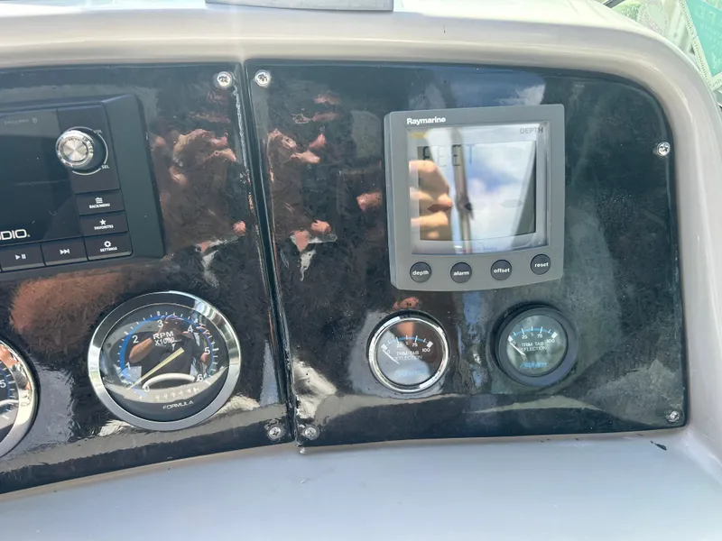 Slide: The Image of Dashboard of a 2004 Formula 400 SS boat with gauges and Raymarine display. - 22
