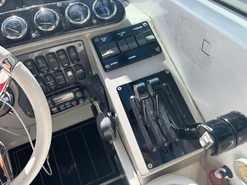 Slide: The Image of Control panel of a 2004 Formula 400 SS boat with steering wheel and throttle levers. - 23