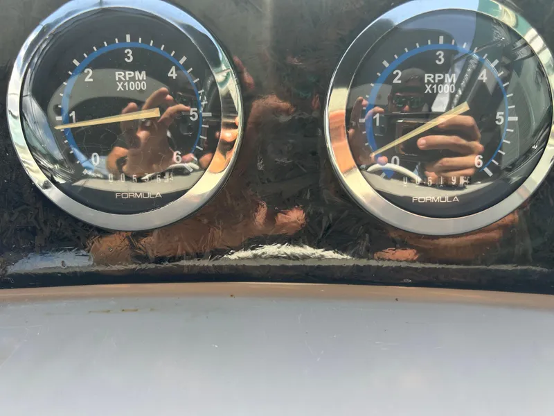Slide: The Image of Close-up of 2004 Formula 400 SS RPM gauges reflecting a person taking a photo. - 26