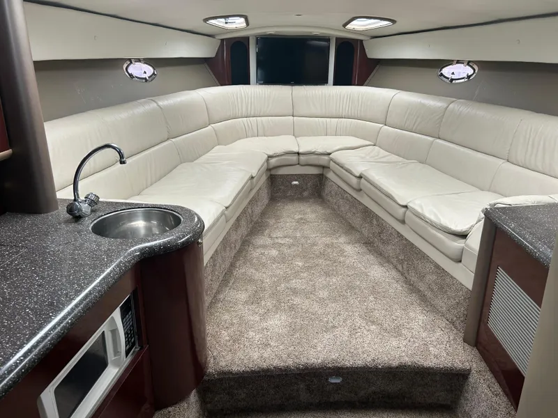 Slide: The Image of Luxurious interior of a 2004 Formula 400 SS boat with plush seating and kitchenette. - 29