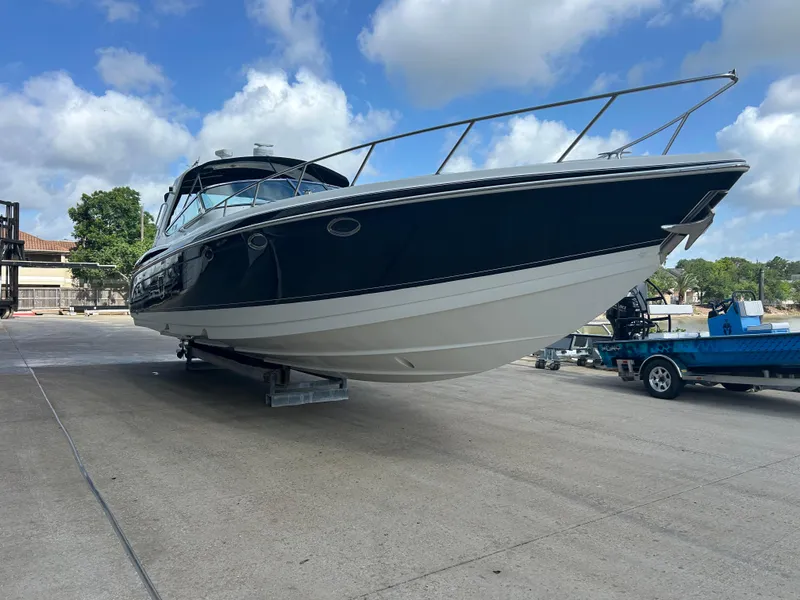 Slide: The Image of 2004 Formula 400 SS boat on a trailer, parked outdoors under a blue sky. - 3