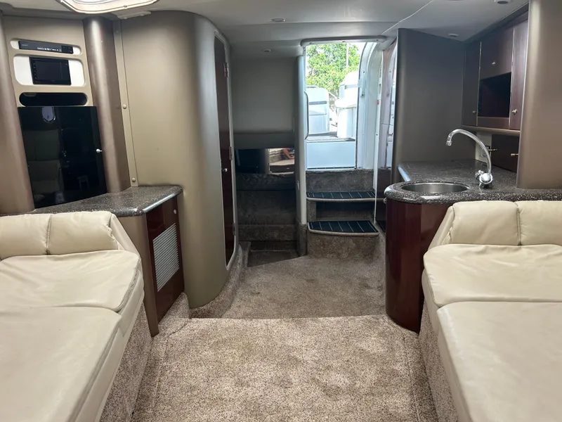 Slide: The Image of Interior of 2004 Formula 400 SS boat with seating, kitchenette, and stairs. - 32