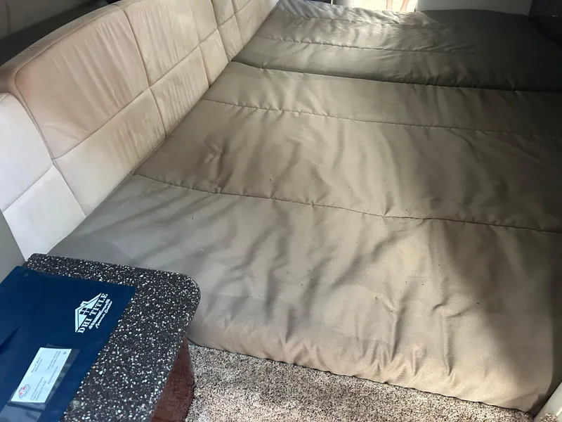 Slide: The Image of Interior of a 2004 Formula 400 SS boat with beige seating and a granite-like table surface. - 34