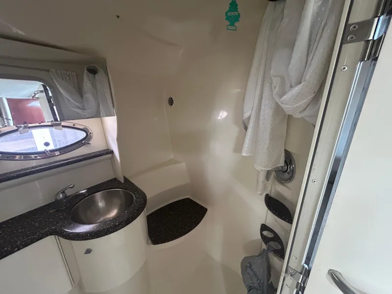 Slide: The Image of 2004 Formula 400 SS boat bathroom with sink, shower, and porthole window. - 36