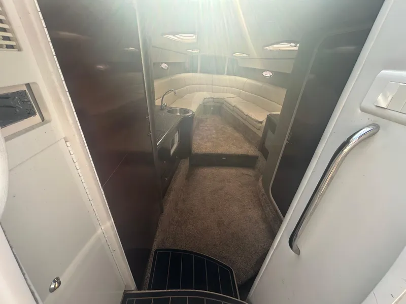 Slide: The Image of Interior of a 2004 Formula 400 SS boat, featuring a cozy seating area and kitchenette. - 39