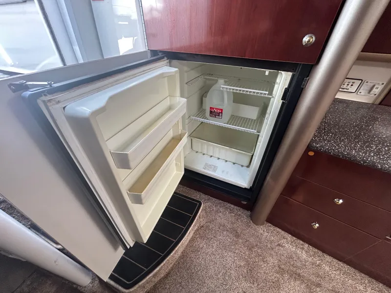 Slide: The Image of Open refrigerator in 2004 Formula 400 SS boat interior, containing a gallon of water. - 41