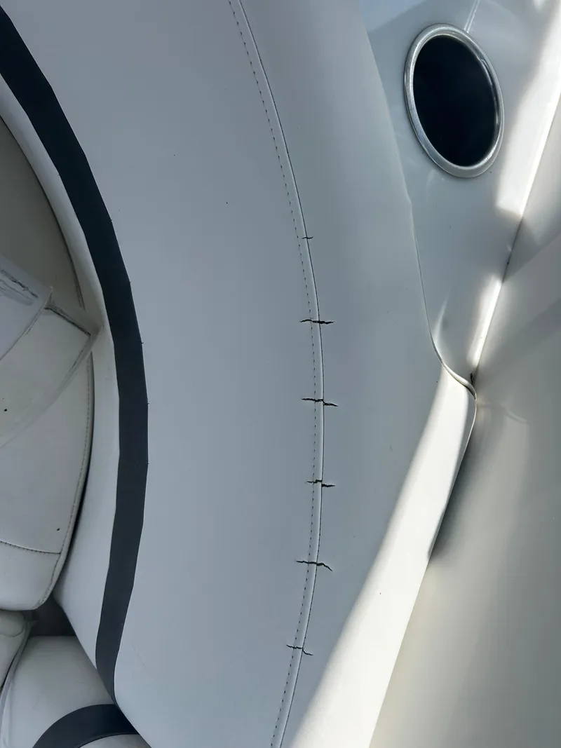 Slide: The Image of White leather upholstery with black stitching on a 2004 Formula 400 SS boat interior. - 43