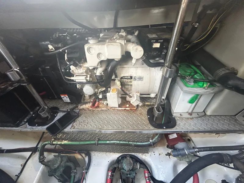 Slide: The Image of Engine compartment of a 2004 Formula 400 SS boat, featuring mechanical components and wiring. - 48