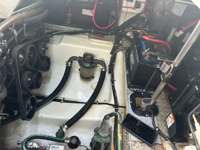 Slide: The Image of Engine compartment of a 2004 Formula 400 SS boat, showing batteries and hoses. - 49