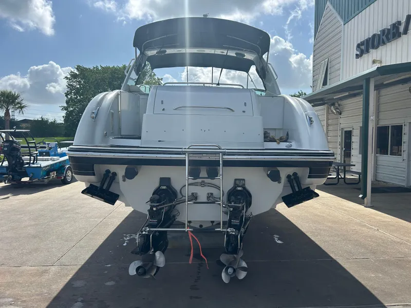 Slide: The Image of 2004 Formula 400 SS boat docked, rear view with dual propellers, under a sunny sky. - 5