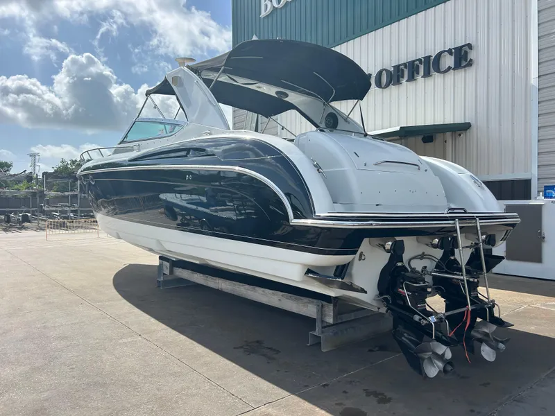 Slide: The Image of 2004 Formula 400 SS boat on display outside an office building under a cloudy sky. - 8