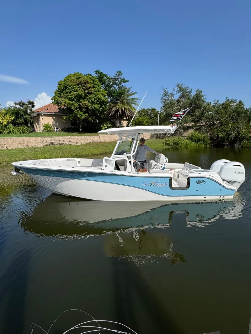 The Image of 2023 Sea Fox 268 Commander boat on a calm waterway, surrounded by lush greenery. - 1