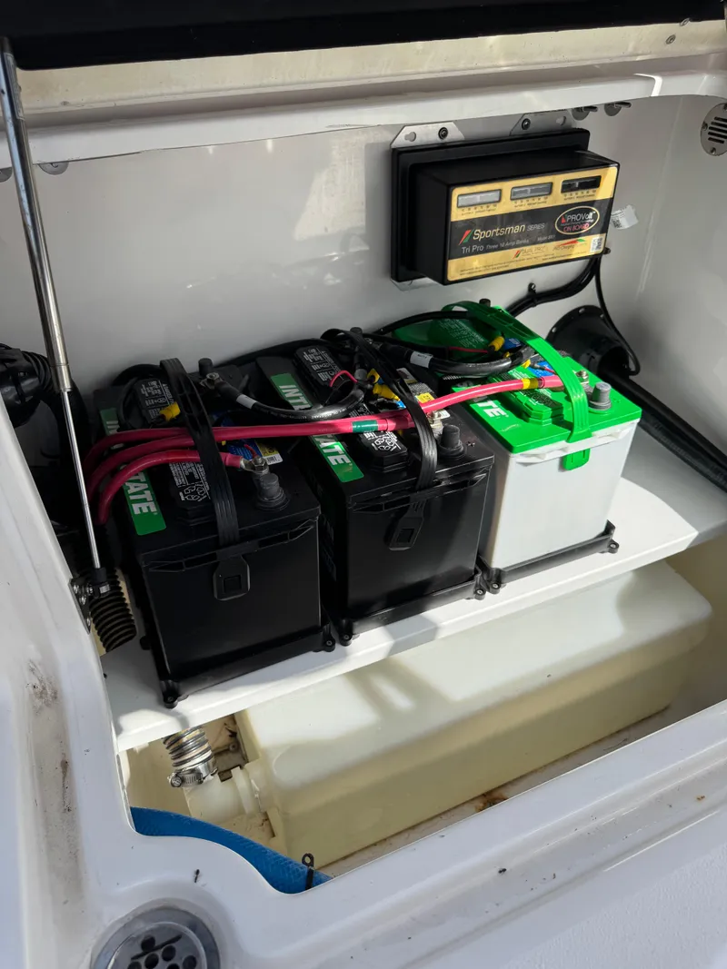 Slide: The Image of Battery compartment of 2023 Sea Fox 268 Commander with multiple batteries and charger. - 21