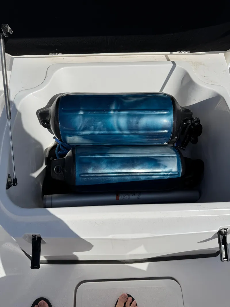 Slide: The Image of Storage compartment on a 2023 Sea Fox 268 Commander with blue fenders inside. - 23