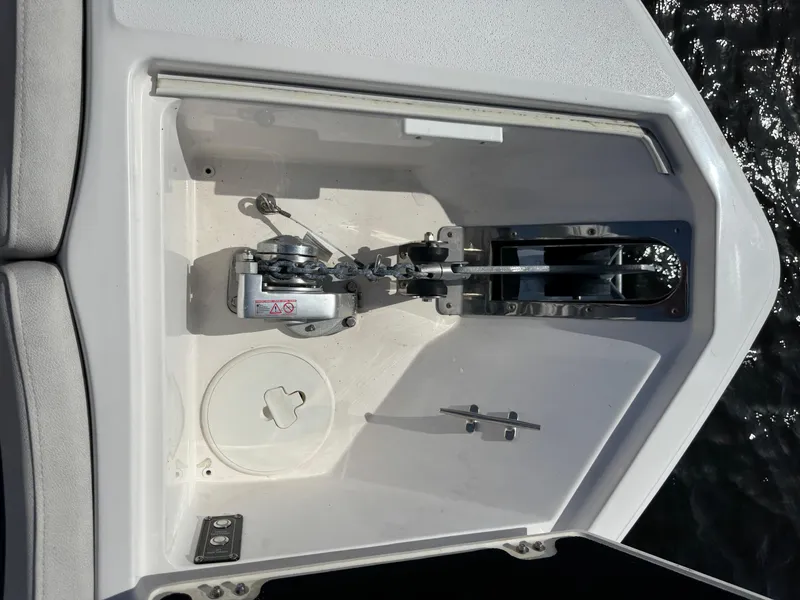 Slide: The Image of 2023 Sea Fox 268 Commander anchor compartment with winch and cleat, open on a sunny day. - 25