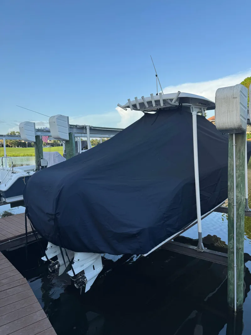 Slide: The Image of Covered 2023 Sea Fox 268 Commander boat on a lift by the dock. - 7